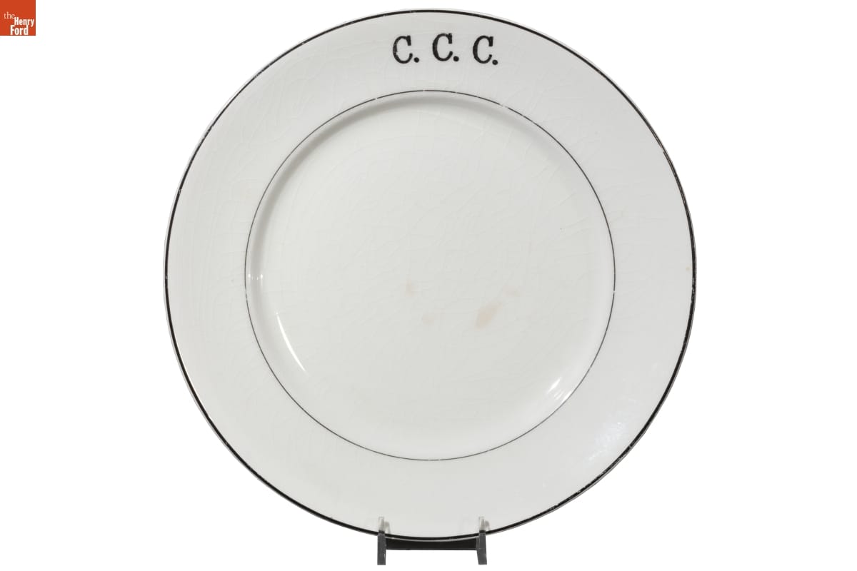 White plate with blue edge and blue internal ring and text "C.C.C."