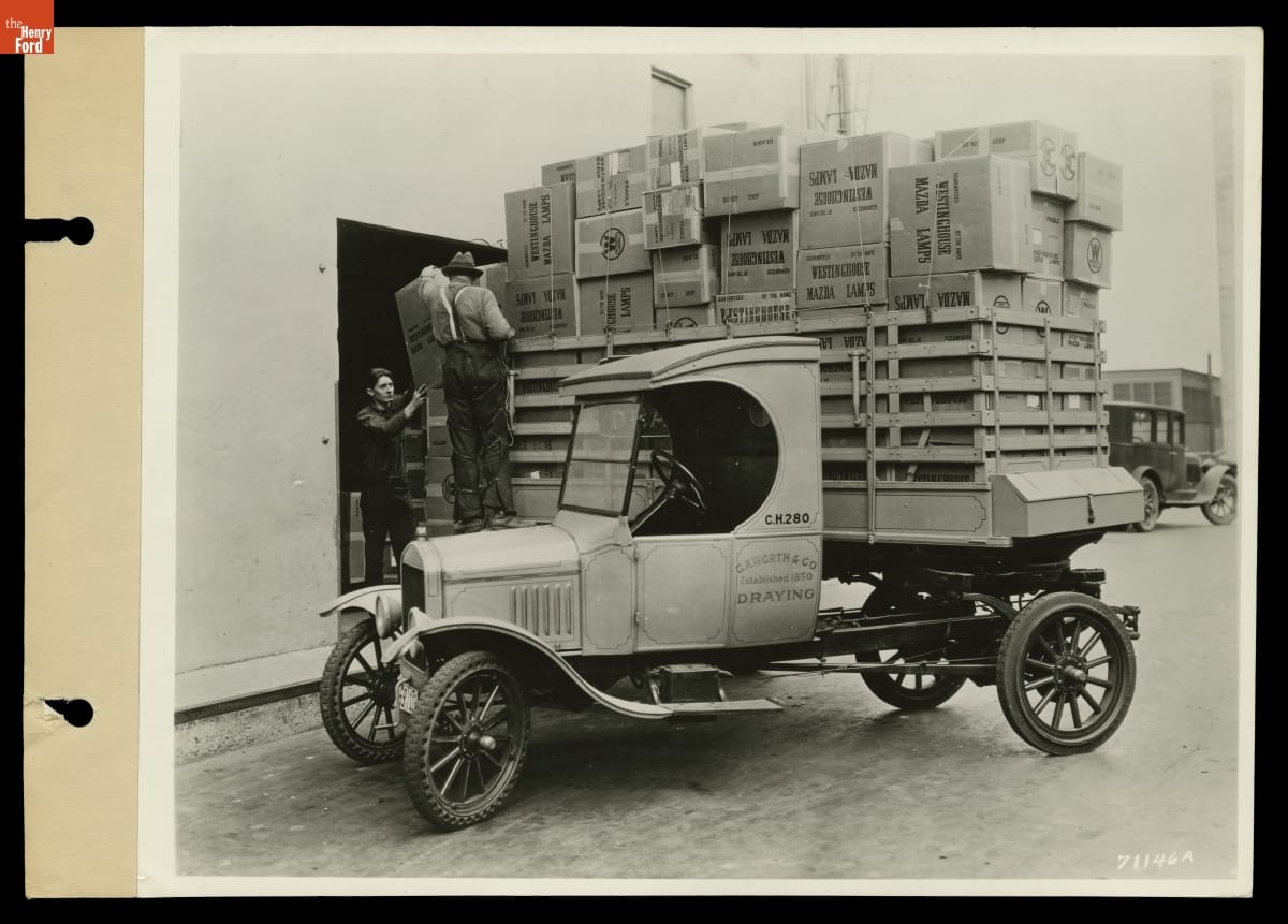 Loading Boxes of Westinghouse Mazda Lamps onto a Ford Truck, 1925.