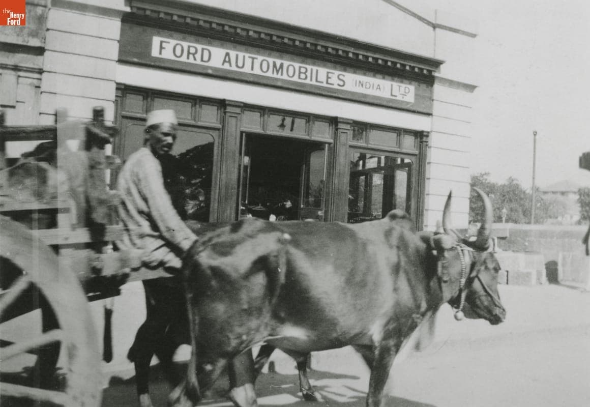 Oxcart Passing Ford Automobiles Dealership, India, 1920