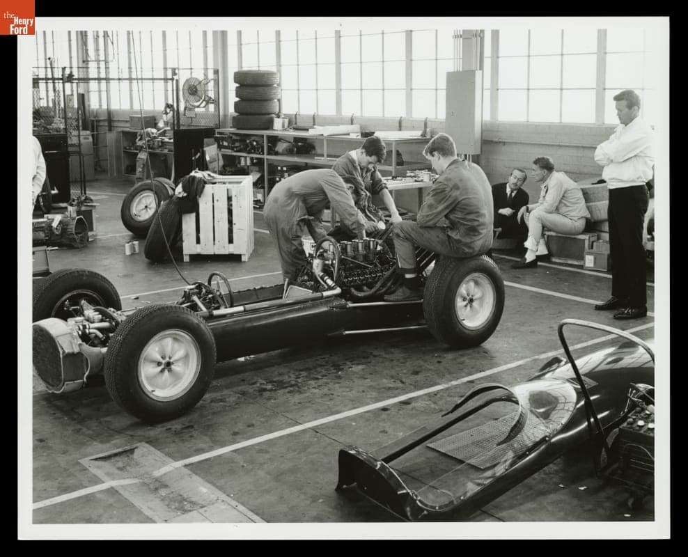Dan Gurney, Colin Chapman and Mechanics at the Lotus Ford Test, February, 1963