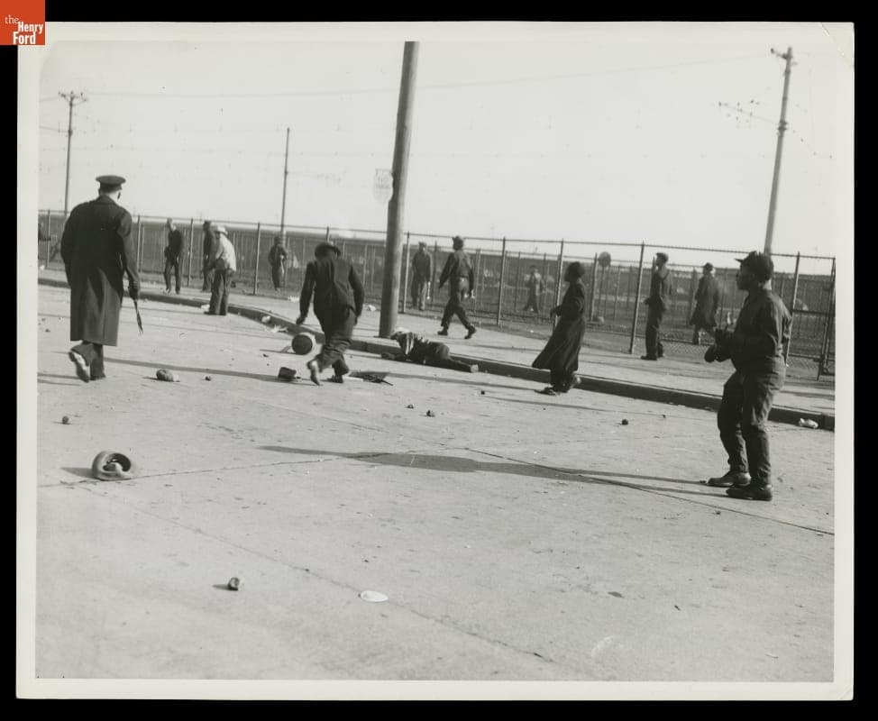 Policeman, Ford Workers and Injured Man on Street after the Battle of the Overpass, Ford Rouge Plant, May 26, 1937
