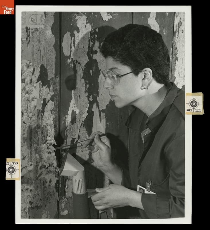 Curator Nancy Bryk Examining Wallpaper in Firestone Farmhouse, Greenfield Village, May 23, 1985