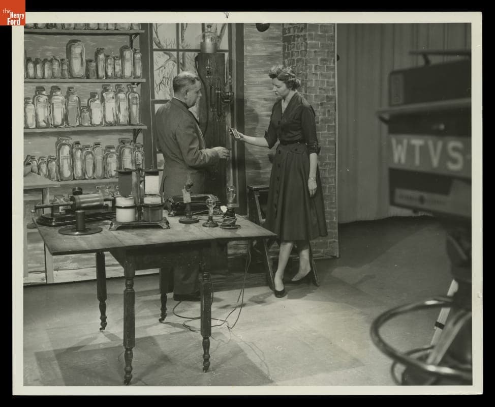 Marion Corwell and Charles Natzel Filming "Window to the Past" in Menlo Park Laboratory, Greenfield Village, 1956