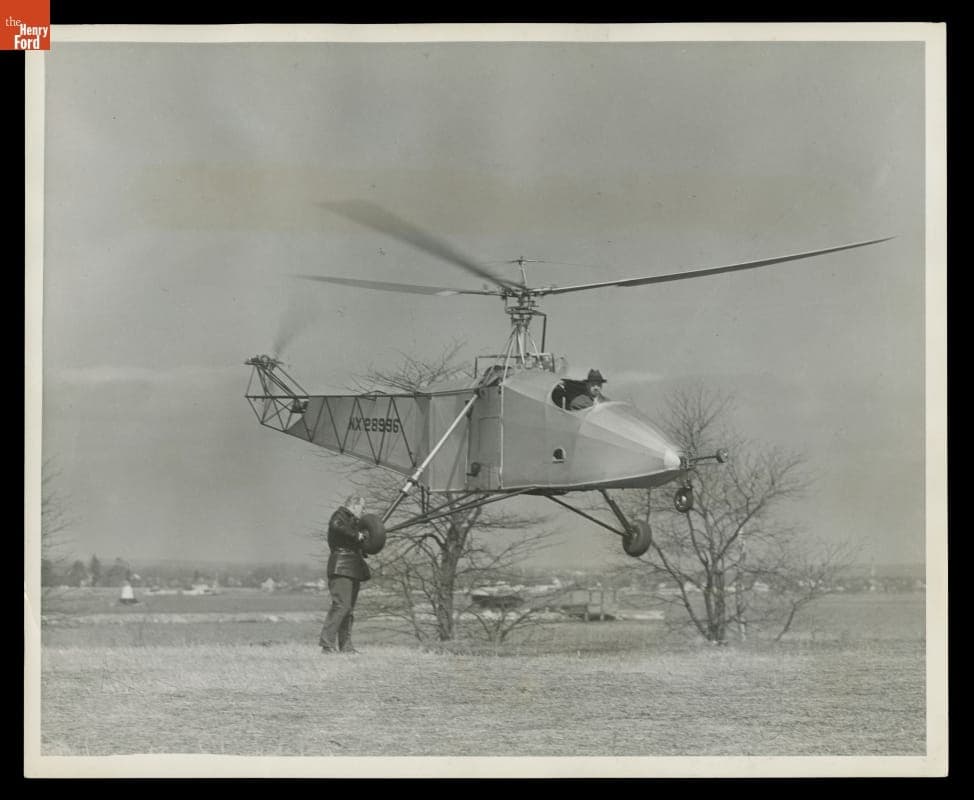 Igor Sikorsky Piloting the VS-300 Helicopter, Hovering While a Wheel is Removed, circa 1942