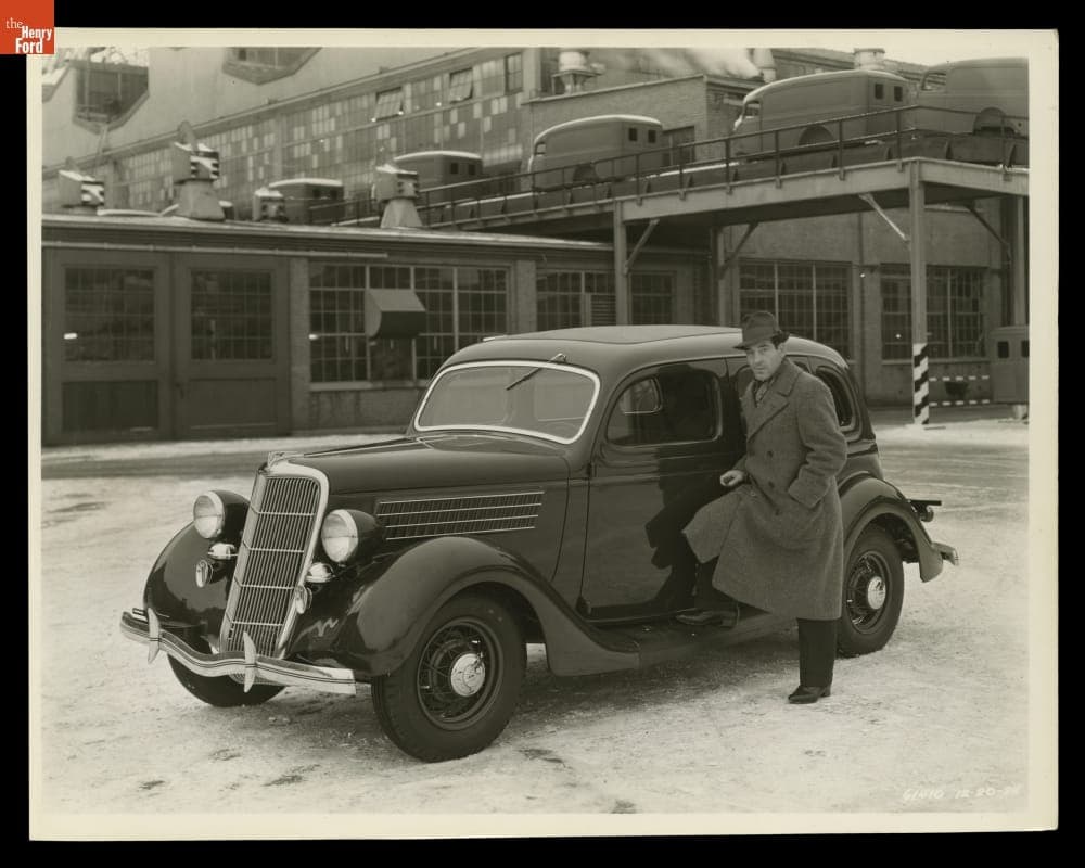 Man with a 1935 Ford V-8 Fordor Sedan, December 1934