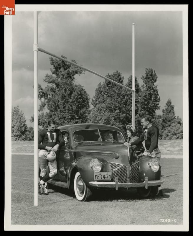 Advertising Photograph, Young Woman and Football Players with a 1940 Mercury Town Sedan