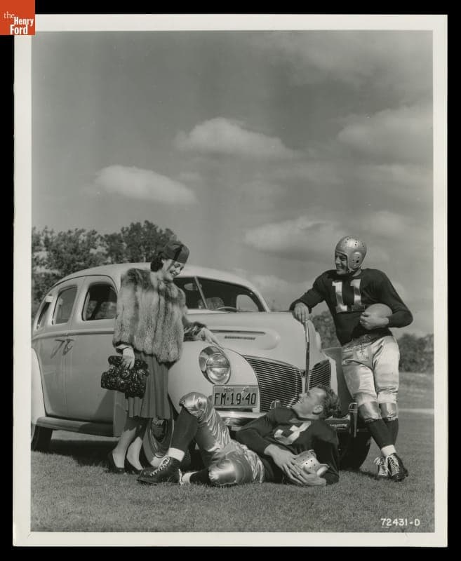 Advertising Photograph, Young Woman and Football Players with a 1940 Mercury Town Sedan