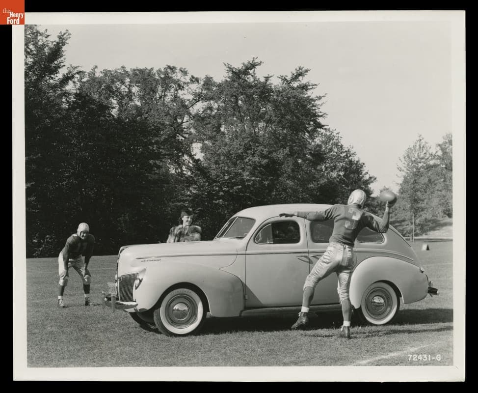 Advertising Photograph, Young Woman and Football Players with a 1940 Mercury Town Sedan