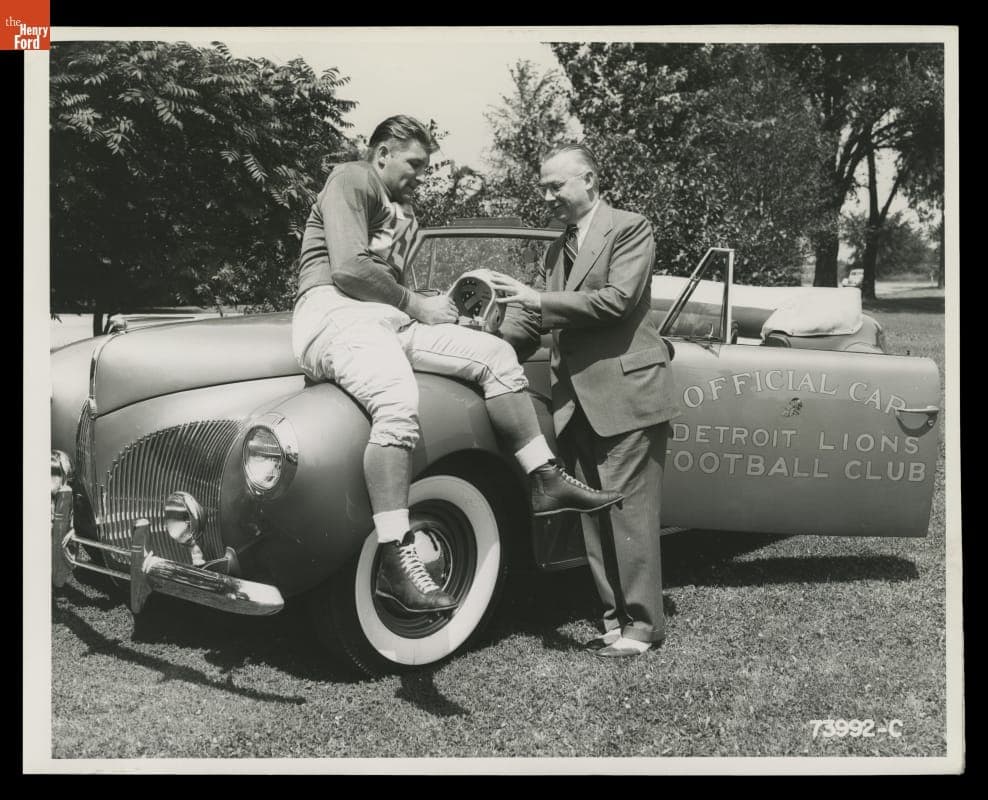 Auto Dealer Stark Hickey and Detroit Lions Player Clem Crabtree with a 1941 Lincoln Zephyr