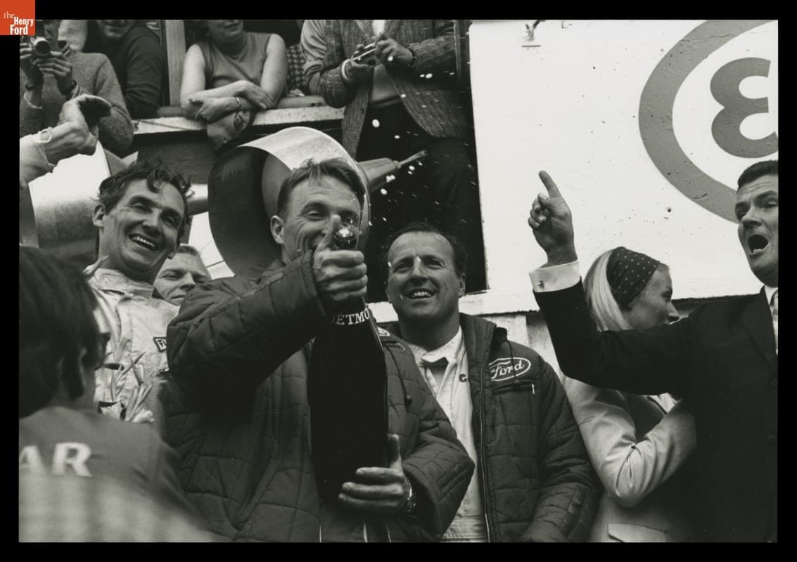 Dan Gurney Popping Cork of Victory Champagne with A. J. Foyt at the 24 Heures du Mans (24 Hours of Le Mans) Race, June 1967