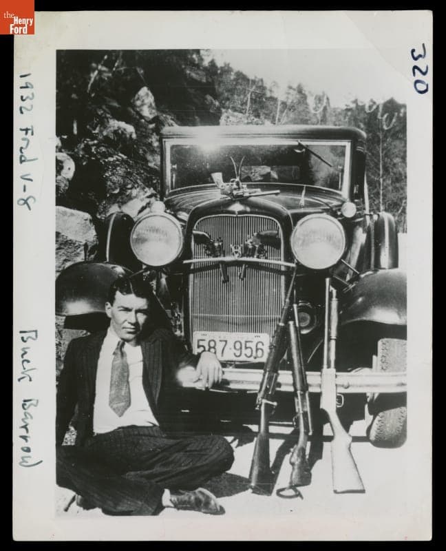 W.D. "Deacon" Jones Posing with Barrow Gang Stolen Weapons and 1932 Ford V-8