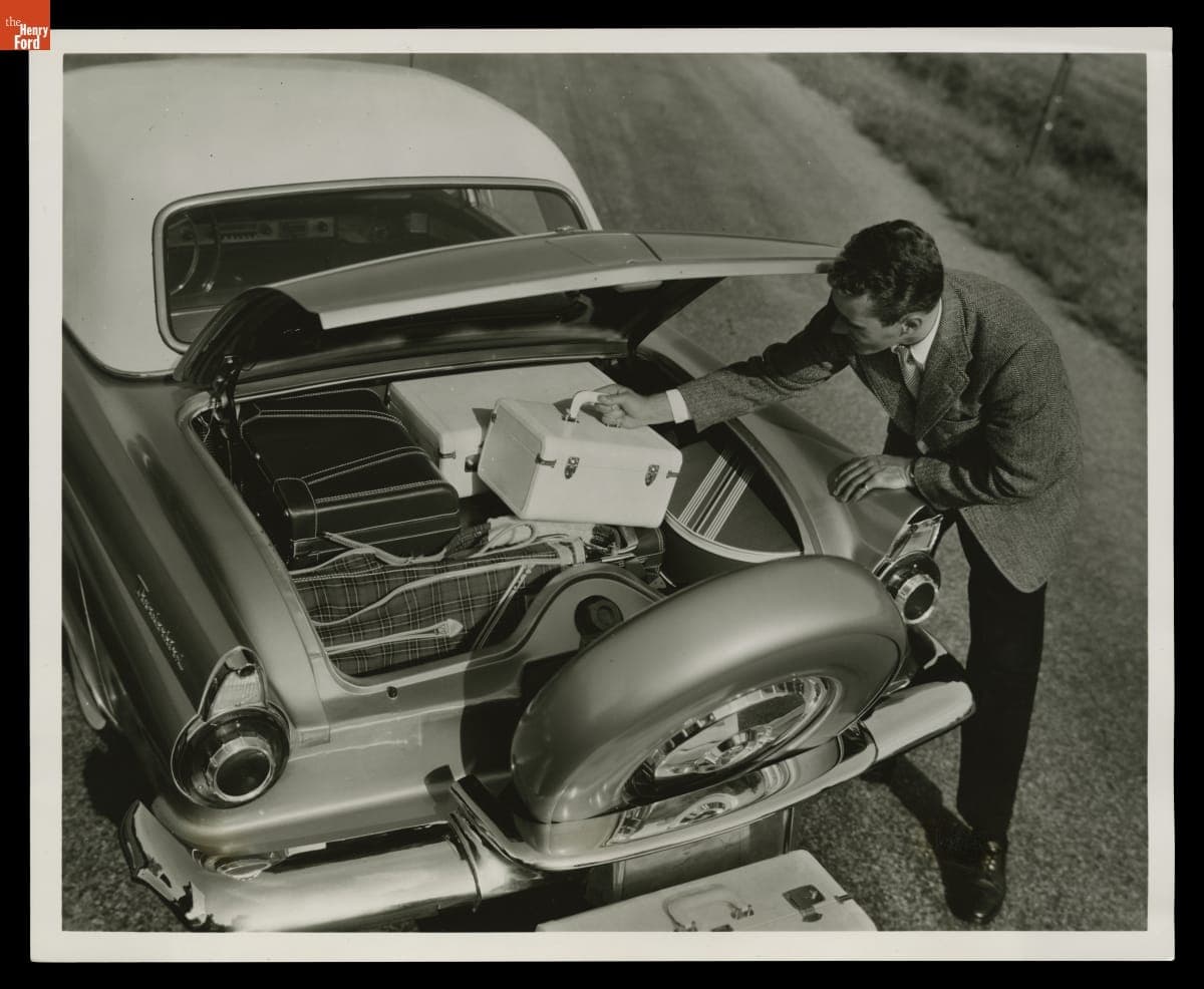 Man Demonstrating Increased Luggage Space in 1956 Ford Thunderbird, May 1955