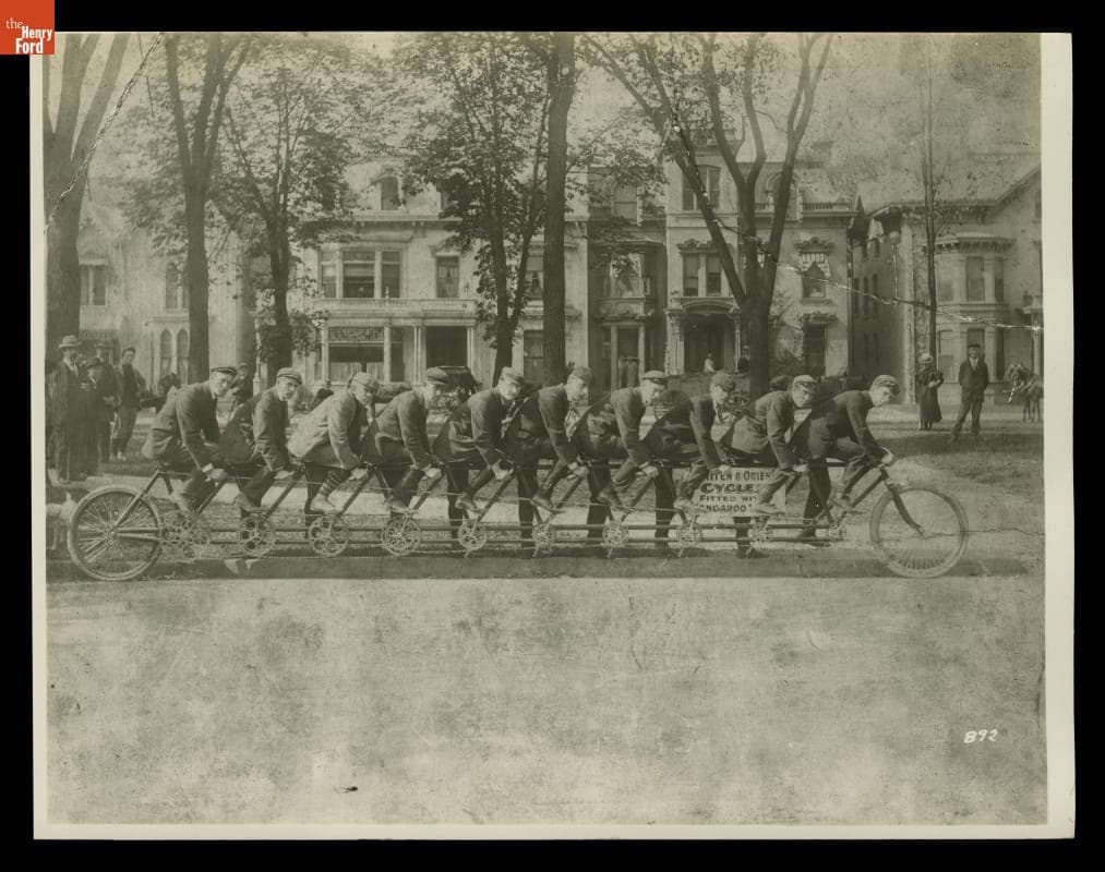 The Orient "Oriten" Ten-Person Bicycle with Cyclists on a Street, Detroit, Michigan, circa 1899