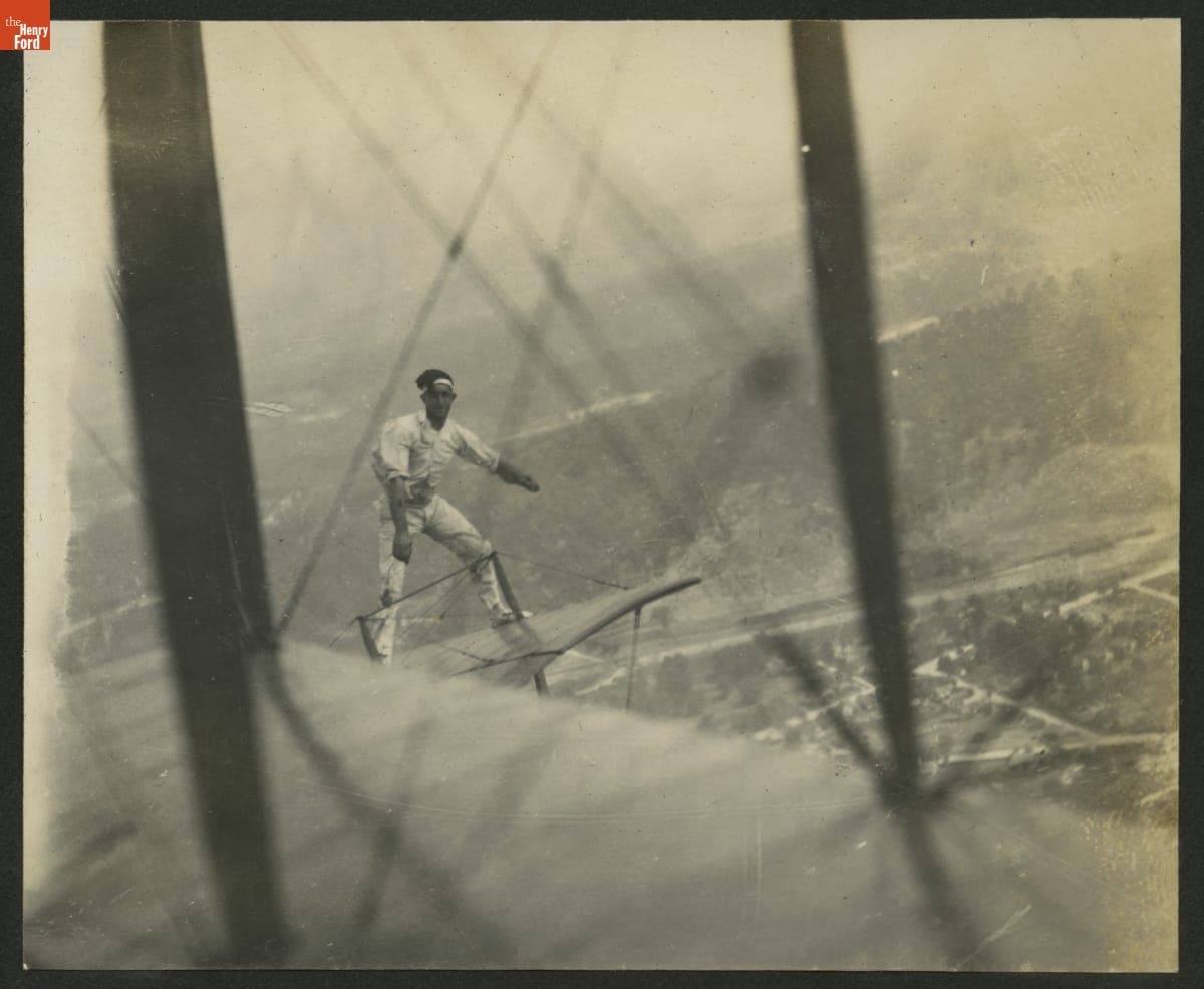 "Jersey" Ringel Performing a Stunt on an Airplane in Flight, circa 1921