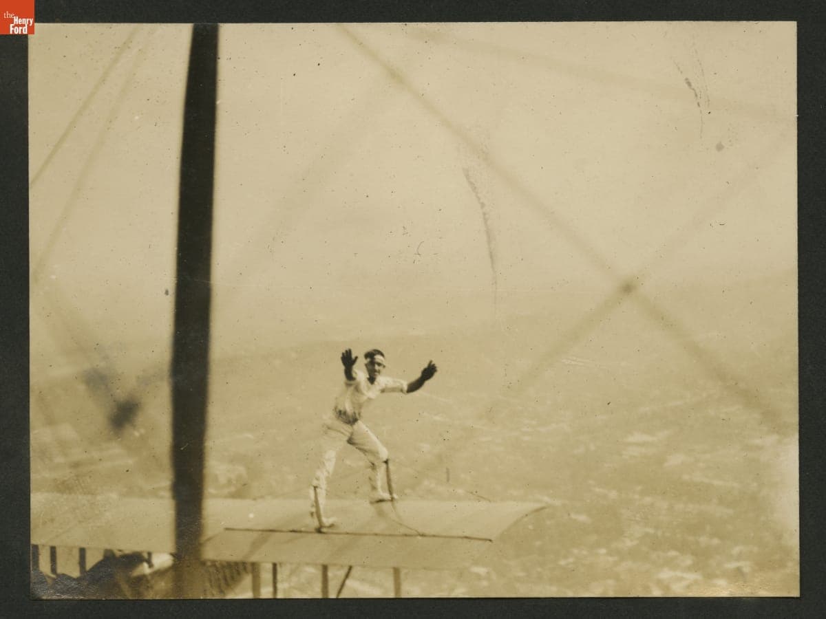 "Jersey" Ringel Performing a Stunt on an Airplane in Flight, circa 1921