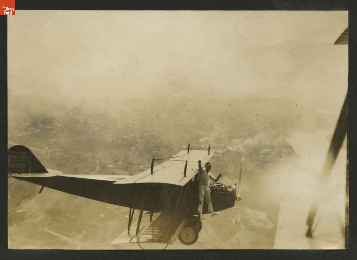 "Jersey" Ringel Performing a Stunt on an Airplane in Flight, circa 1921