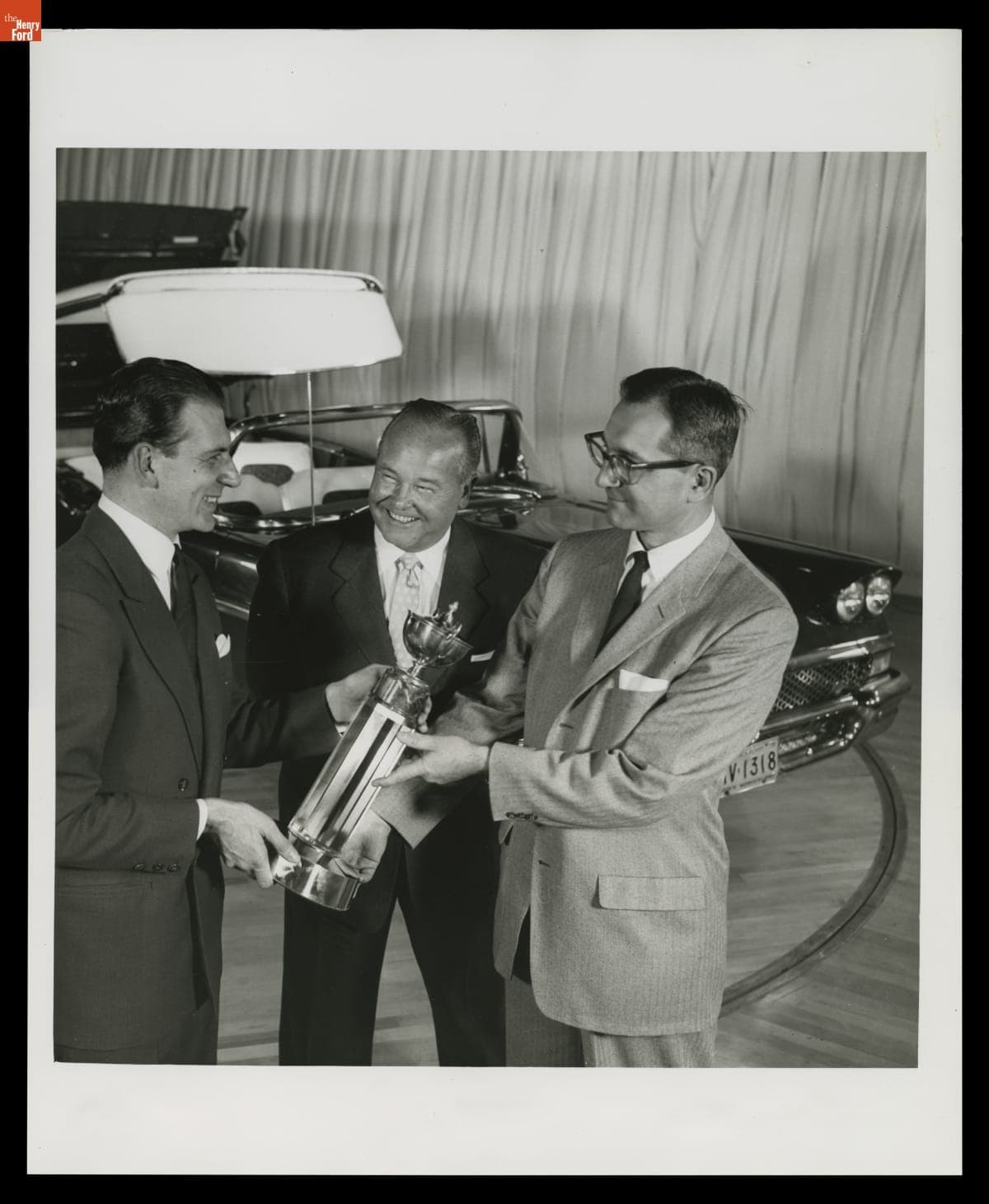 Italian Consul Eric da Rin Presenting Trophy to Joseph Oros and George Walker for the Ford Retractable Hardtop, January 1958