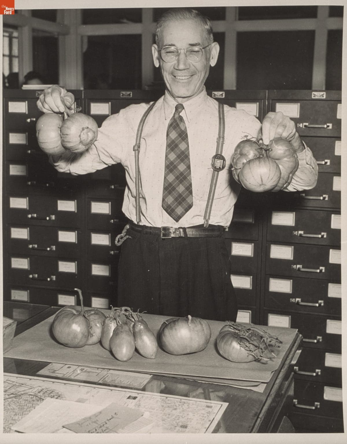 Tony Caruso Displaying Homegrown Tomatoes in the Employment Office at the Ford Motor Company Rouge Plant, September 1943