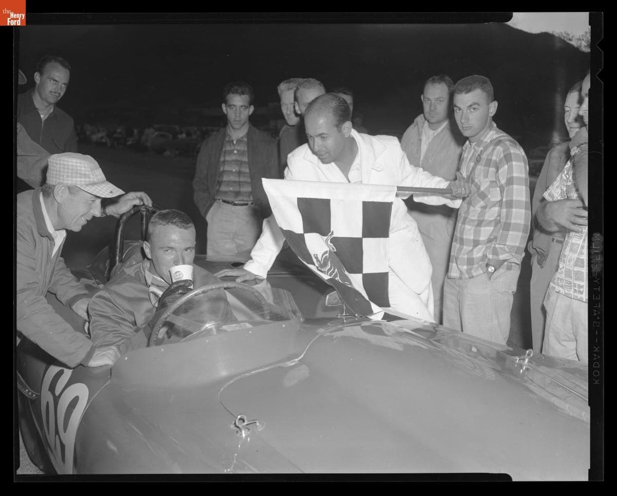 Dan Gurney with Checkered Flag at the Paramount Ranch Sports Car Road Races, December 1957