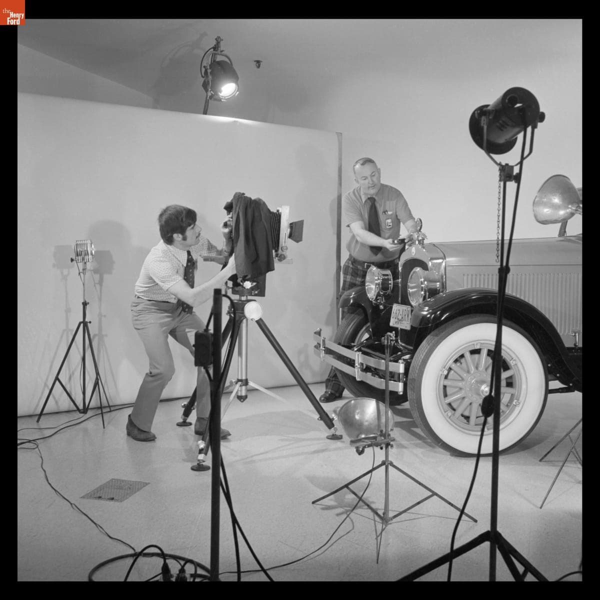 Rudy Ruzicska and Carl Malotka Photographing an Automobile in Henry Ford Museum, April 1976