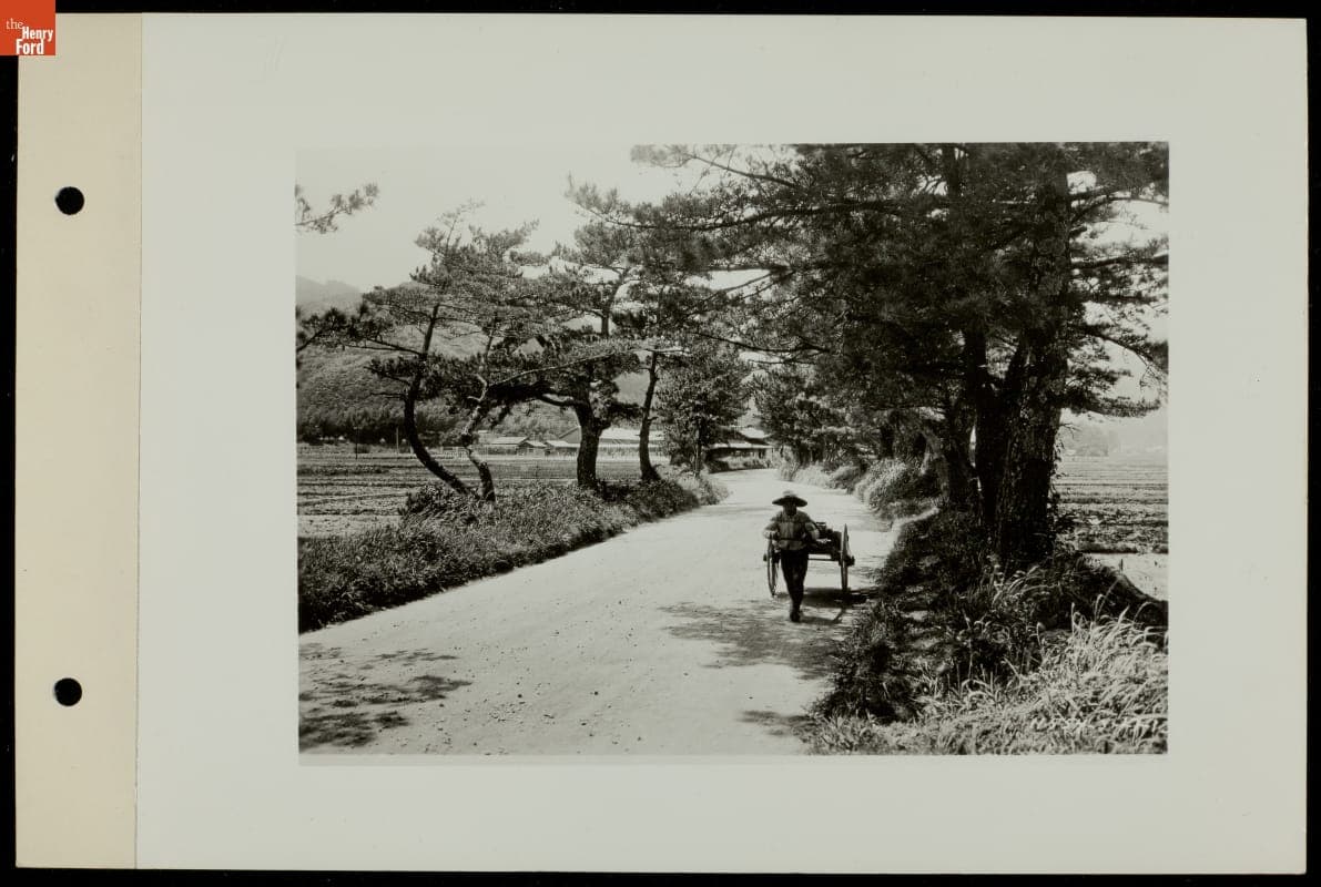 Man Pulling Rickshaw on Road, circa 1930