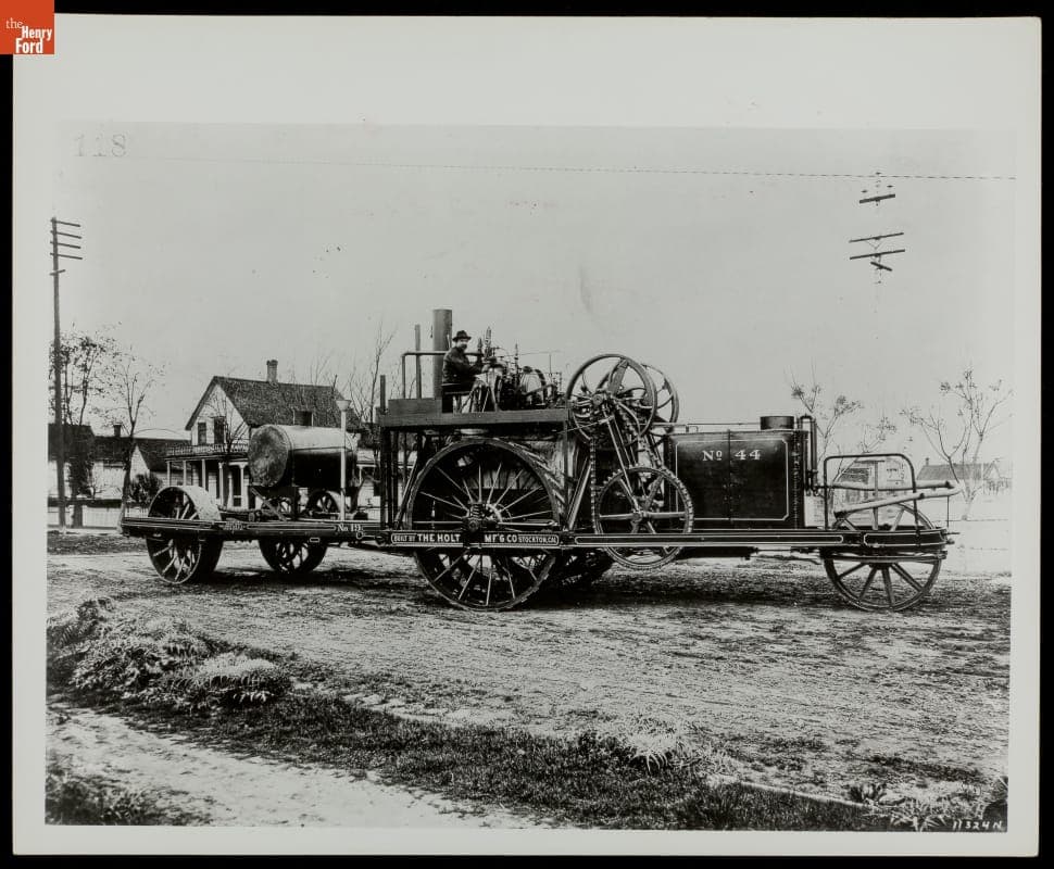 Man Sitting at Controls of a Modified Holt Traction Steam Engine, circa 1900