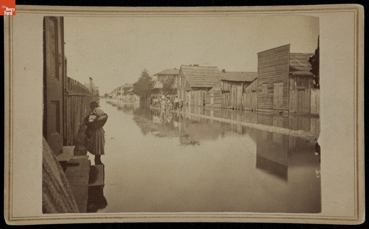 Woman with Basket on a Flooded Street, circa 1865