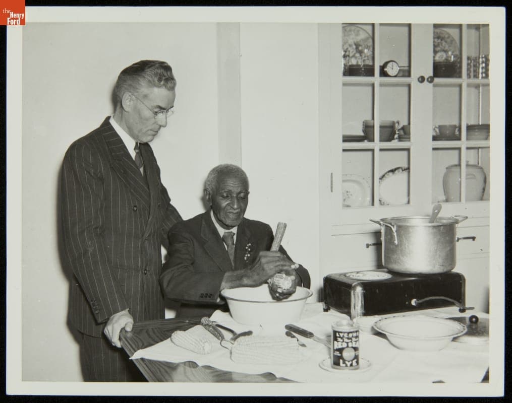 Floyd Starr Watches as George Washington Carver Shells Corn, Starr Commonwealth School, Albion, Michigan, 1939