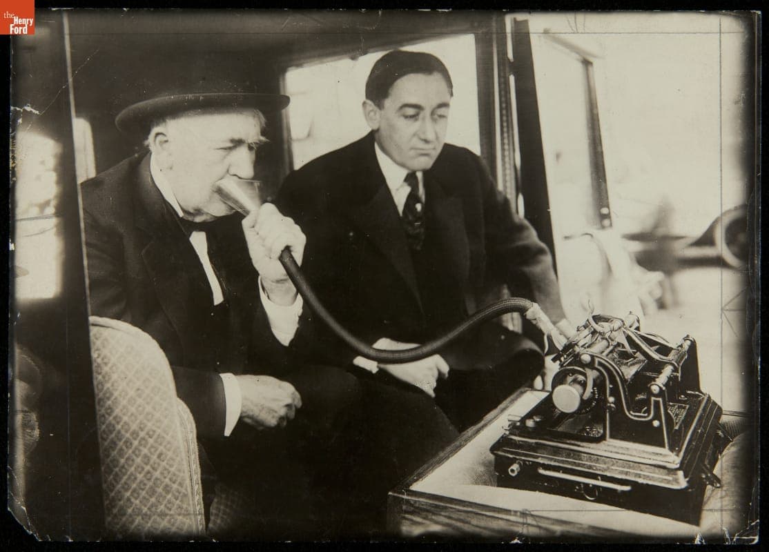 Thomas Edison and C. L. Edholm Using Dictating Machine in an Automobile, circa 1920