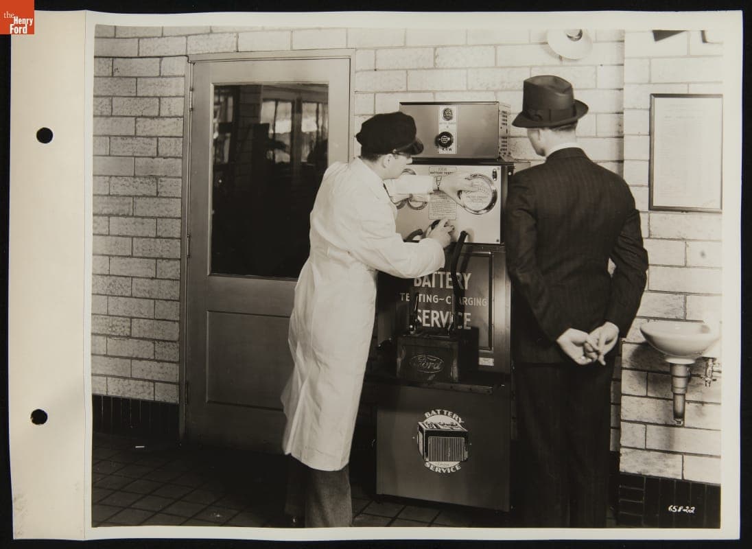 Customer Watching Service Attendant Test Battery with K.R. Wilson Battery Tester, April 1946