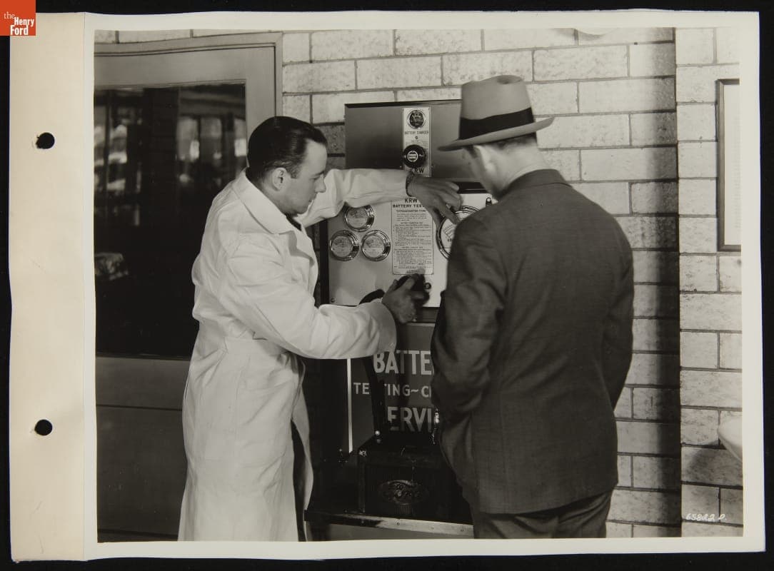Customer Watching Service Attendant Test Battery with K.R. Wilson Battery Tester, April 1946