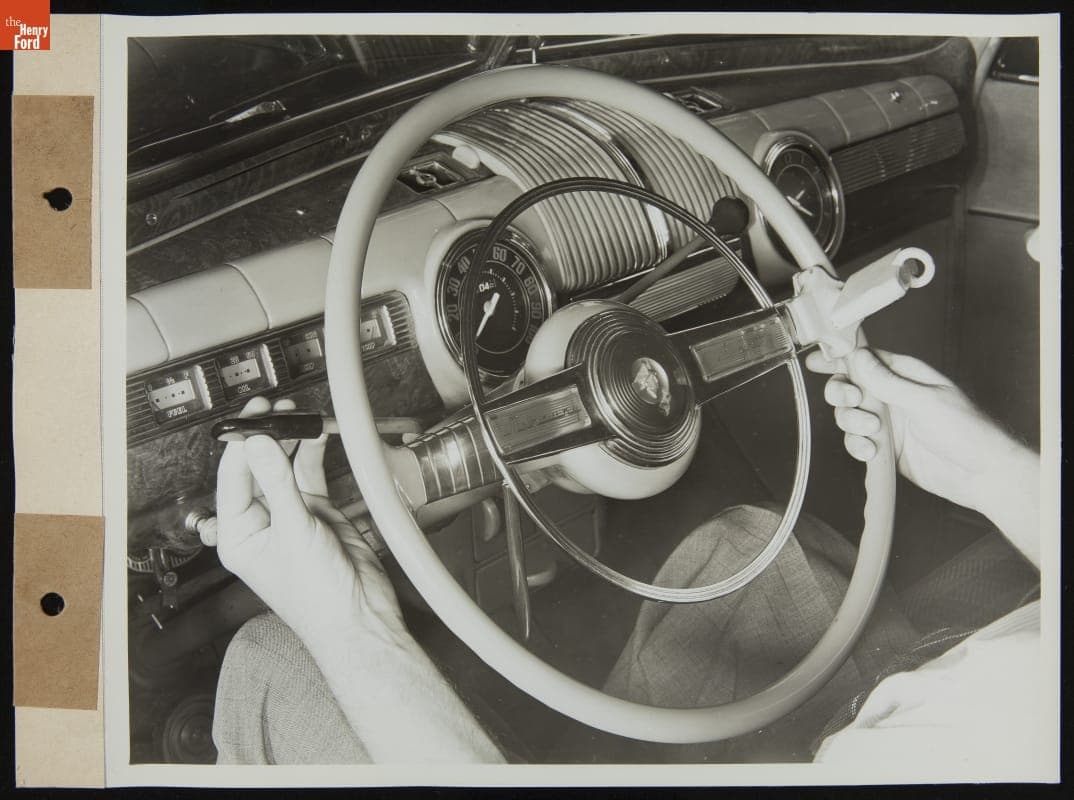 Driver Demonstrates Steering Wheel Attachments on Mercury Car for Handicapped Drivers, August 1945