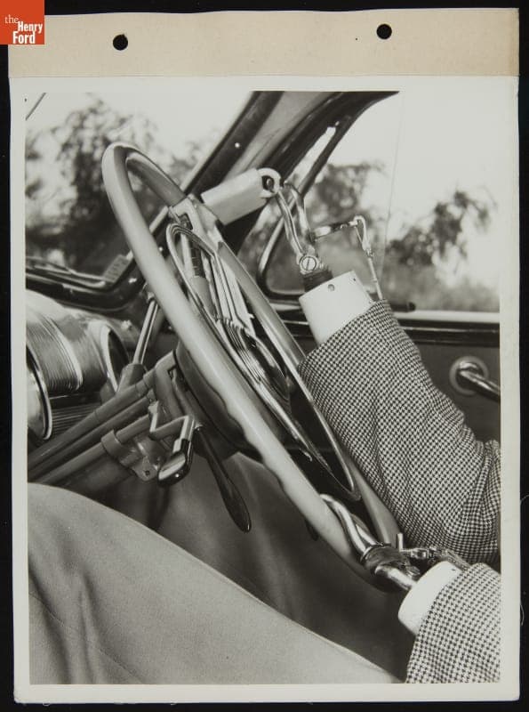 Driver Demonstrates Steering Wheel Attachments on Mercury Car for Handicapped Drivers, August 1945