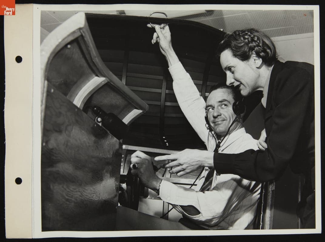 Paula Lind with Pilot Carl J. Lund in Link Trainer Flight Simulator, Willow Run Bomber Plant, May 1943