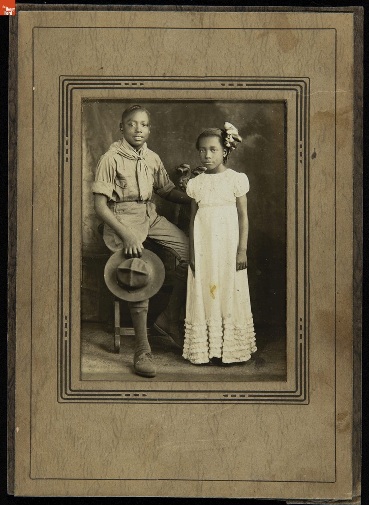 Portrait of a Boy in a Scout Uniform and a Girl in a White Dress, circa 1920