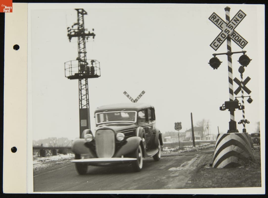 Lincoln Automobile Driving Over Railroad Crossing, December 1934