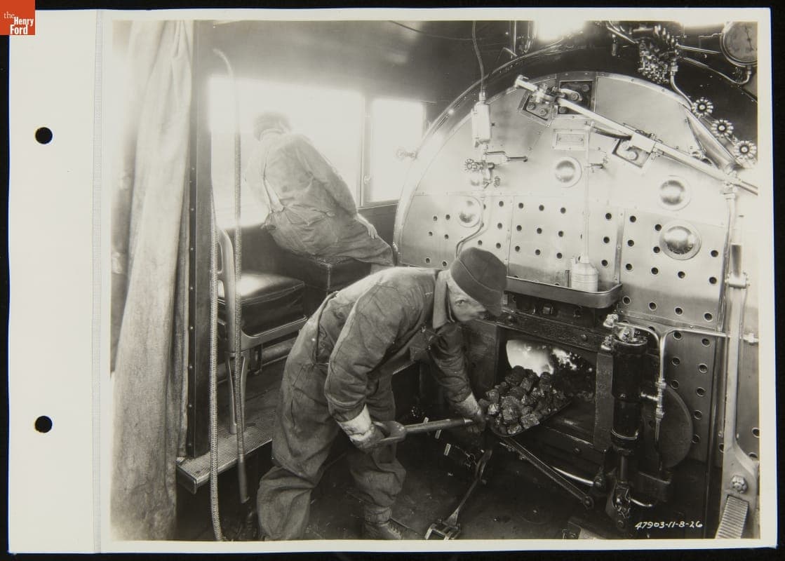 Railroad Fireman Shoveling Coal inside Steam Locomotive, Detroit, Toledo & Ironton Railroad, November 1926