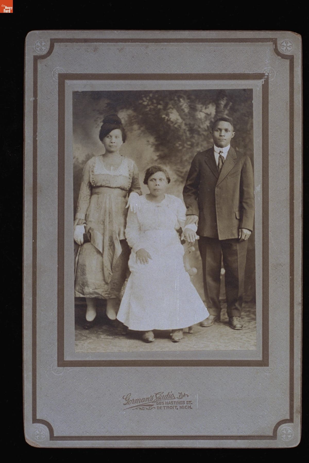 Two Women and One Man in Front of a Painted Backdrop, 1916-1920