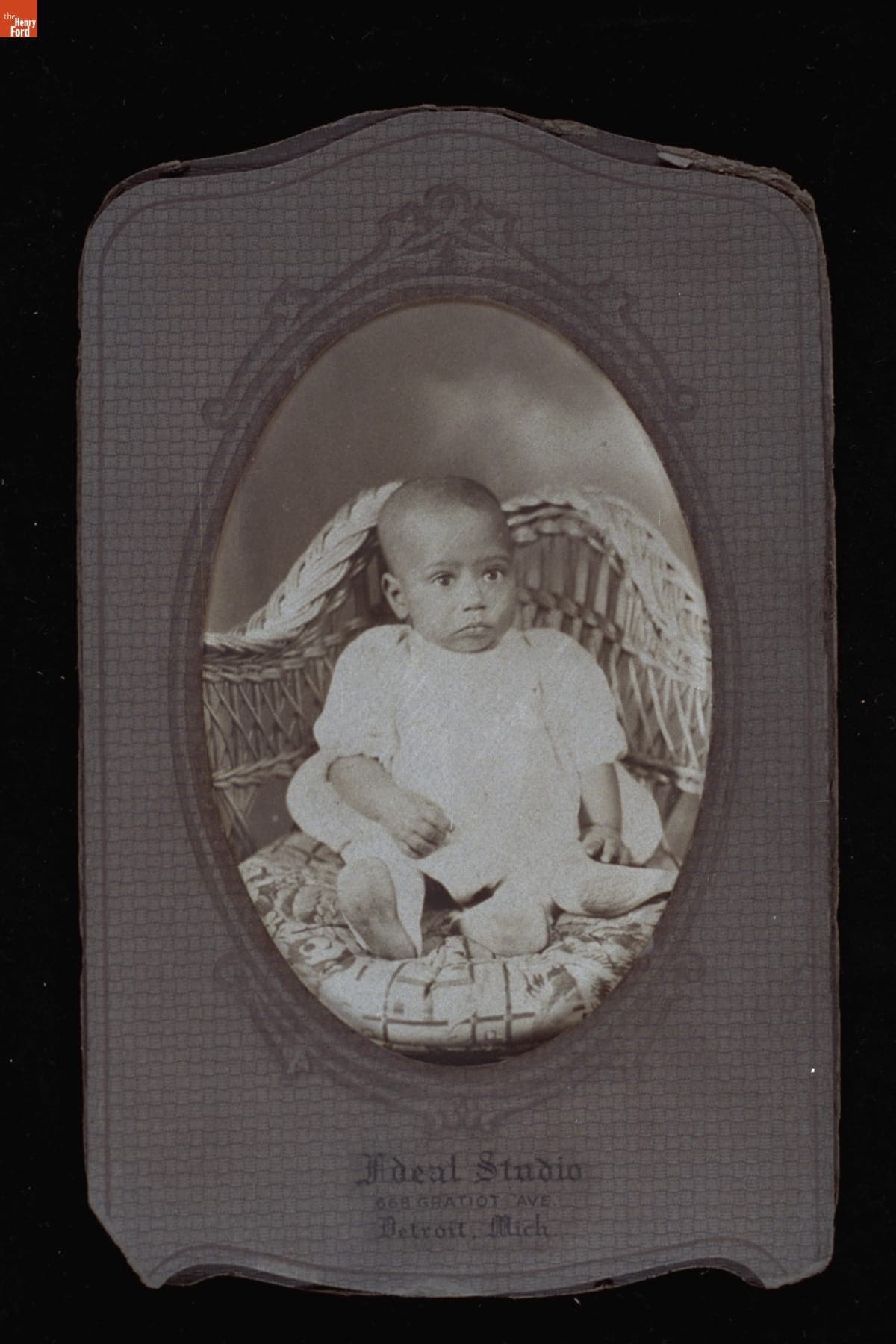 Infant Sitting in a Wicker Chair, circa 1935