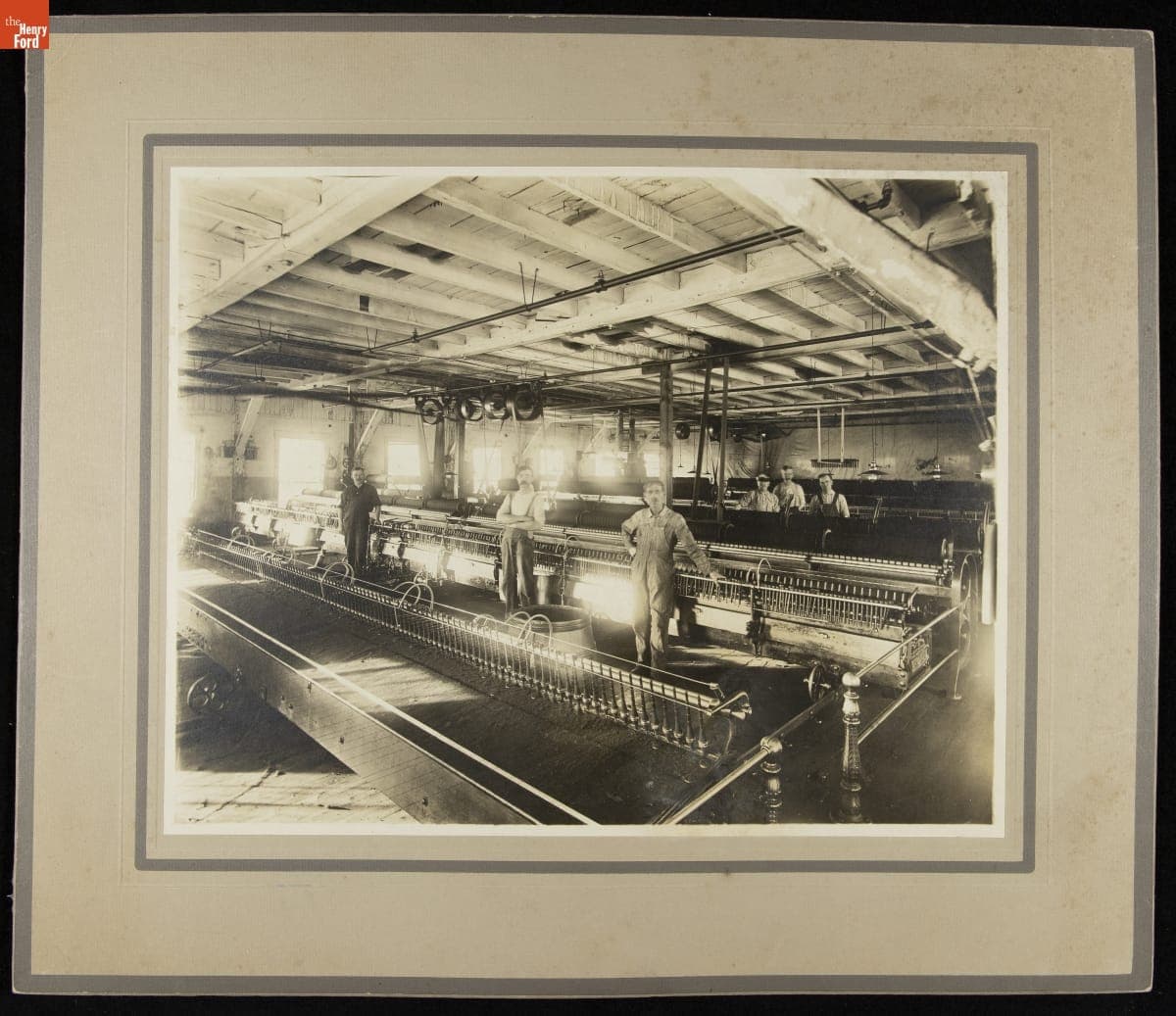 Workers at a Textile Mill Standing next to Machinery, circa 1910