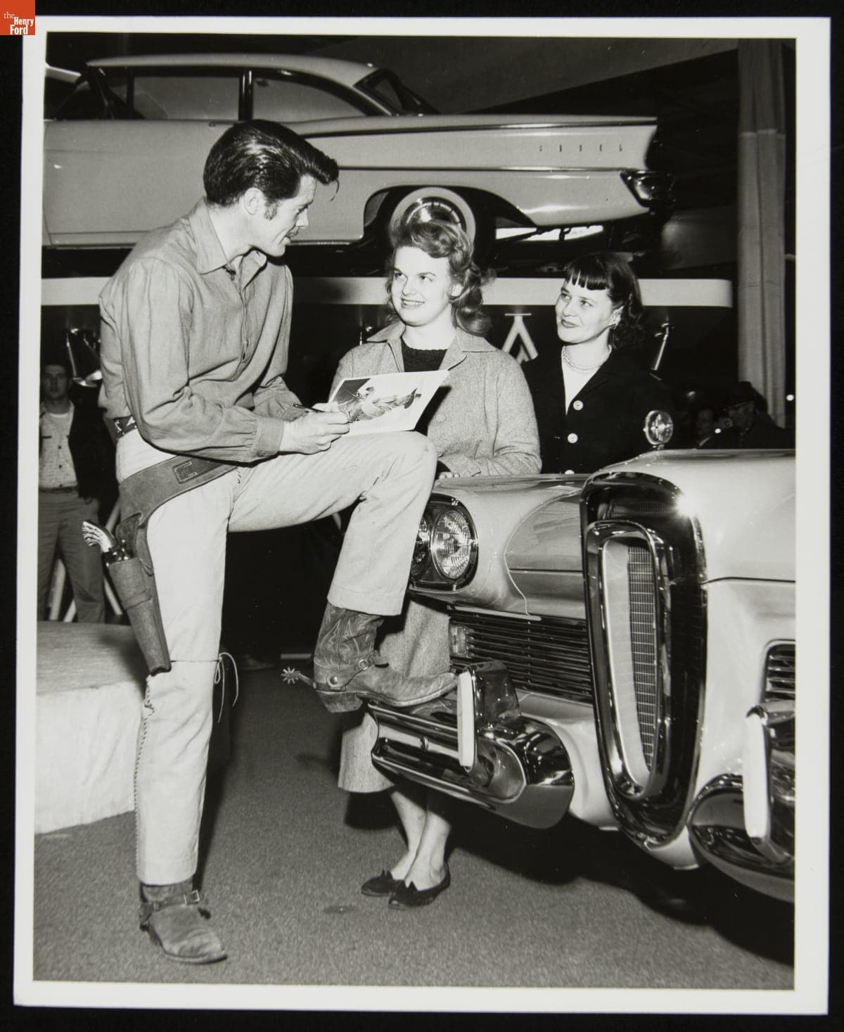 Robert Horton Signing Autographs while Leaning on a 1958 Edsel Automobile, circa 1957