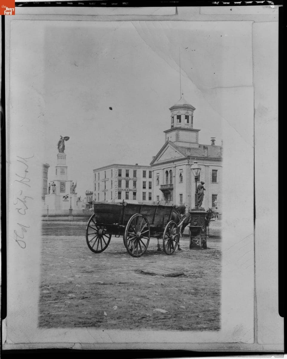 Horse-drawn Market Wagon in front of the Michigan Soldier's and Sailors' Monument and Detroit's Original City Hall Building, 1872