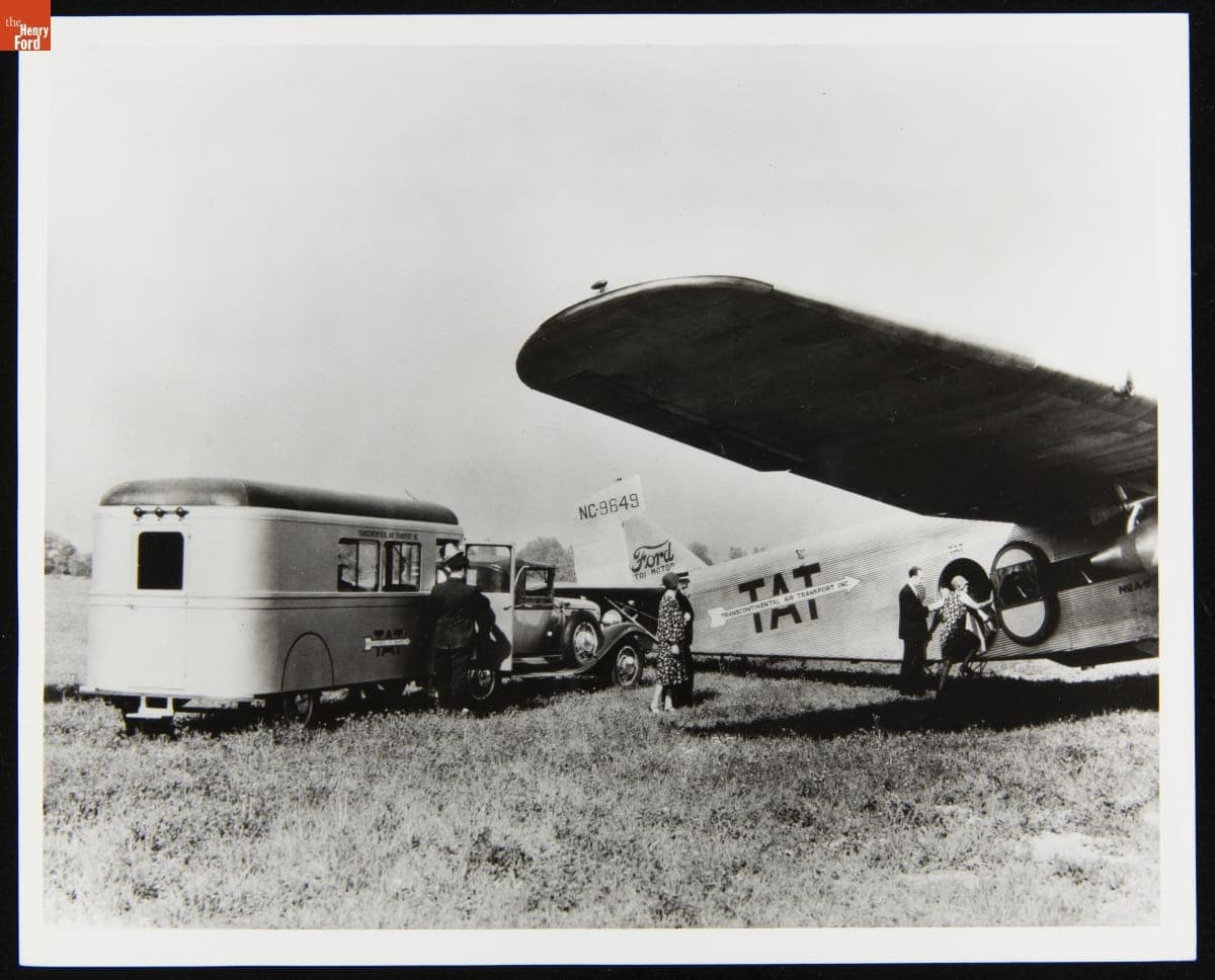Passengers Leaving a Curtiss Aerocar and Boarding a Ford Tri-Motor 5AT-20 Airplane, circa 1930