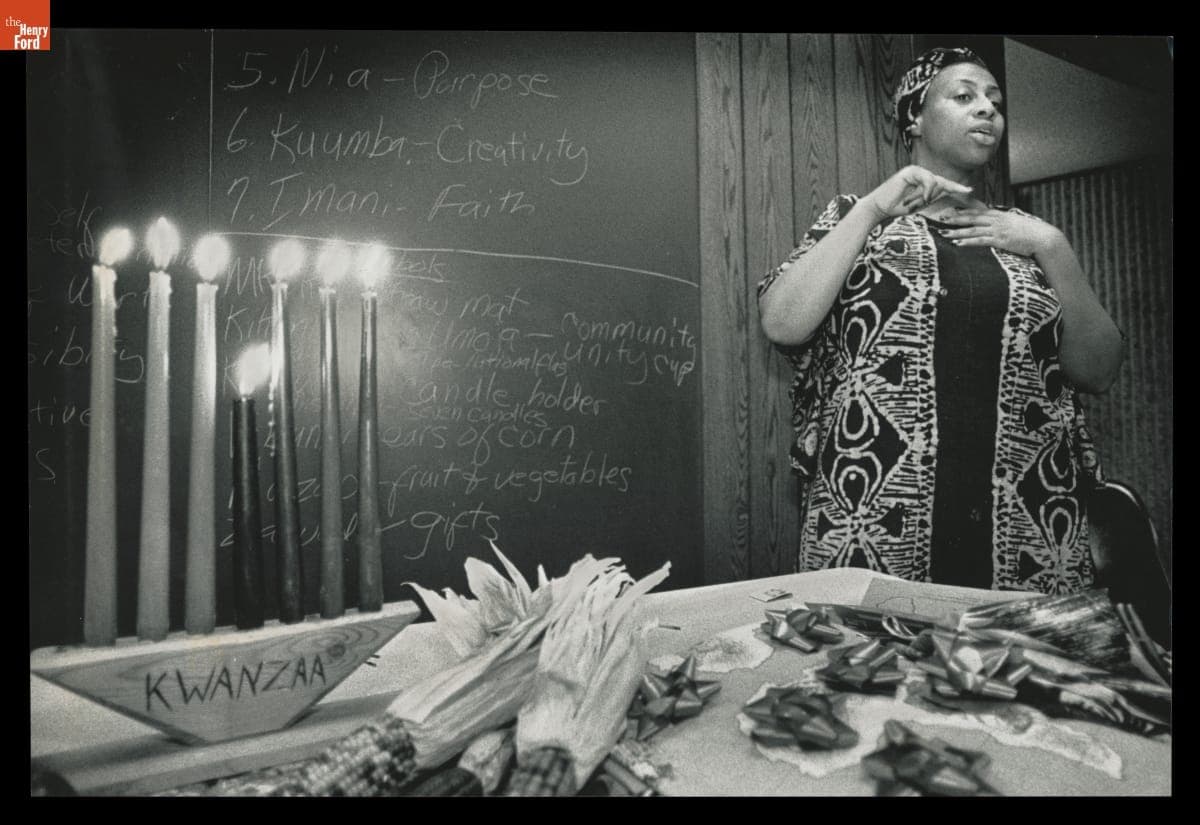 Woman Standing in Front of a Blackboard Describes the Holiday of Kwanzaa, 1990
