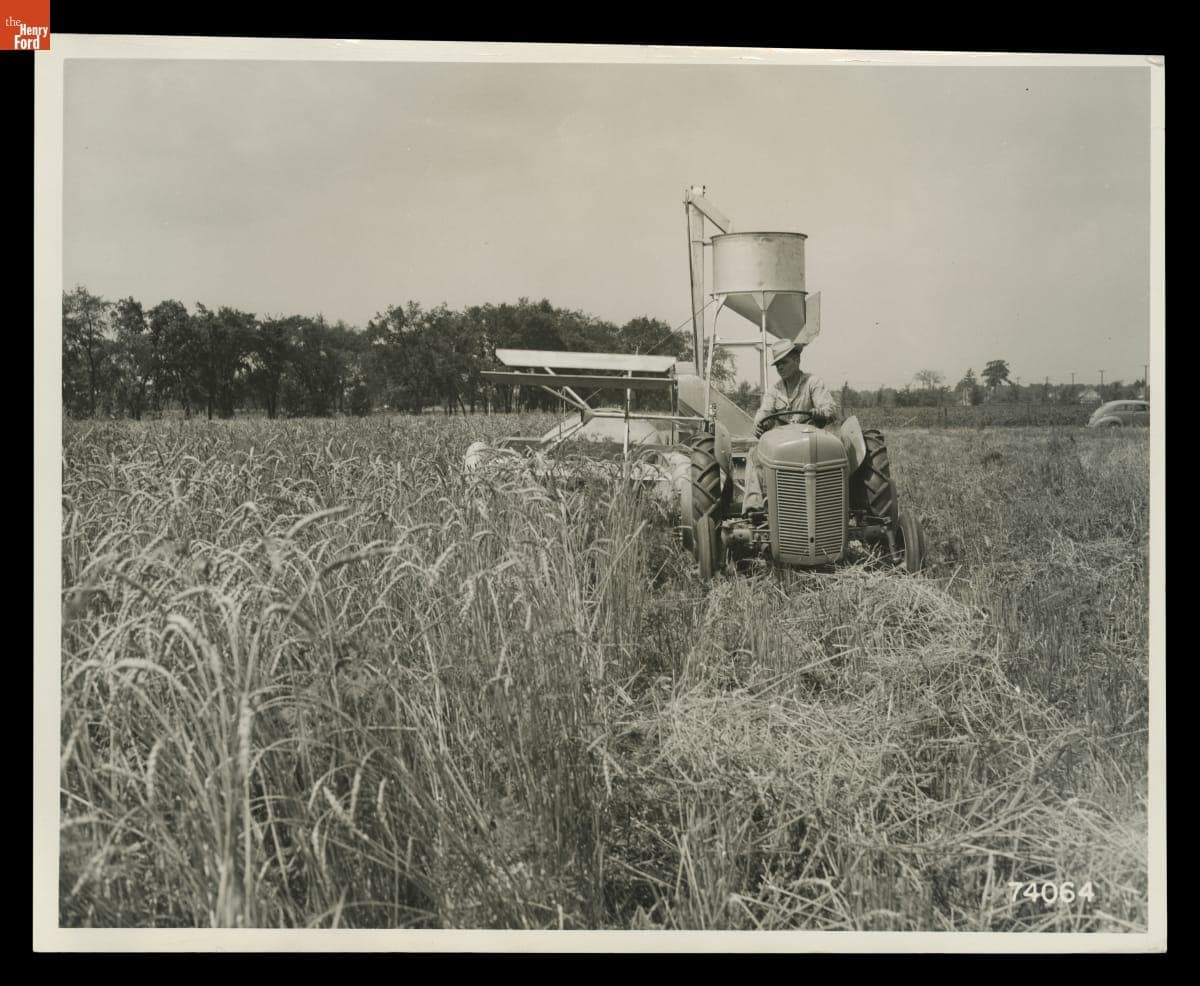 Man Driving a Ford-Ferguson Tractor with Ferguson Combine Attached, August 1940