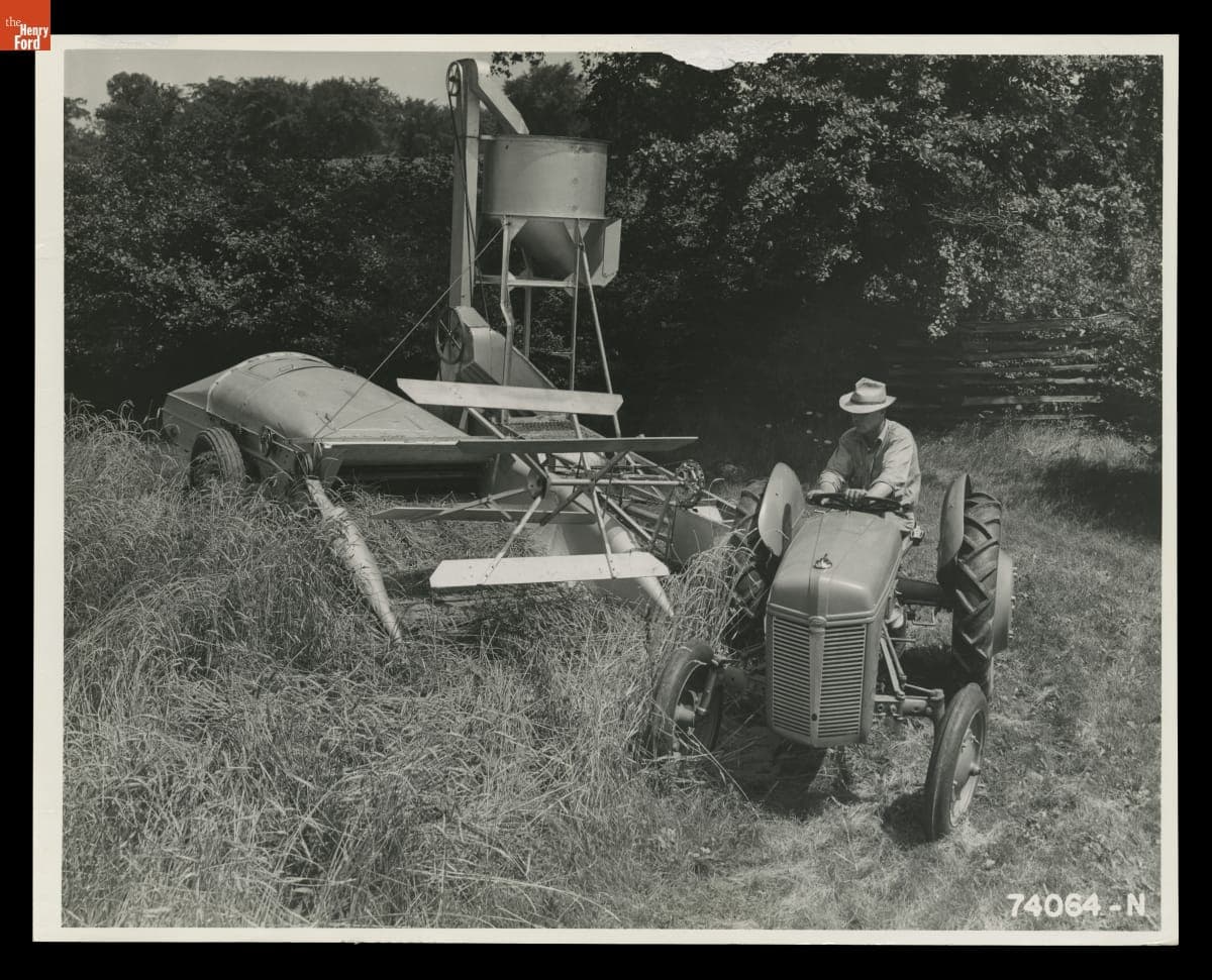 Man Driving a Ford-Ferguson Tractor, Pulling a Ferguson Combine, August 1940