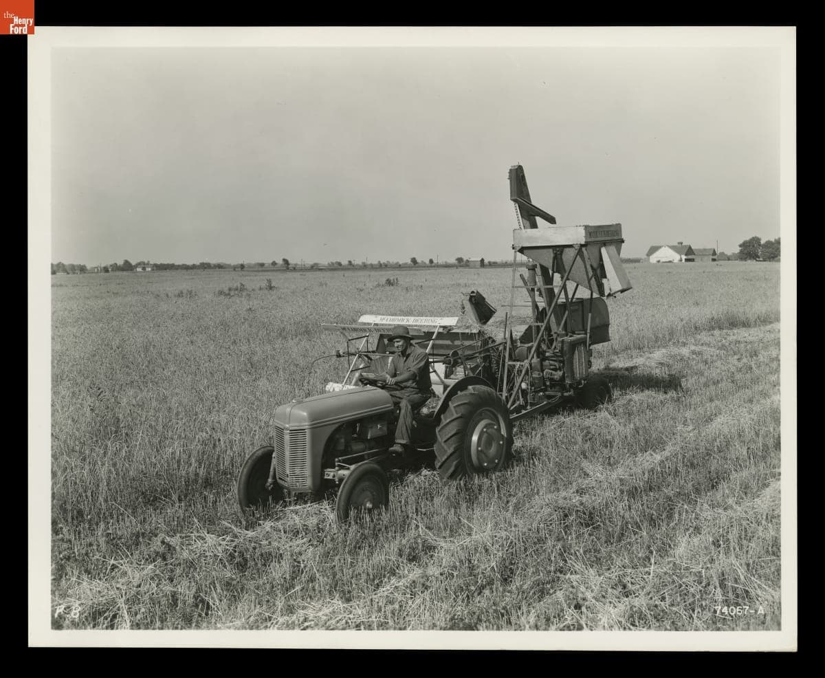 Man Harvesting Wheat Using a Ford-Ferguson Tractor with Combine Attached, Indiana, August 1940