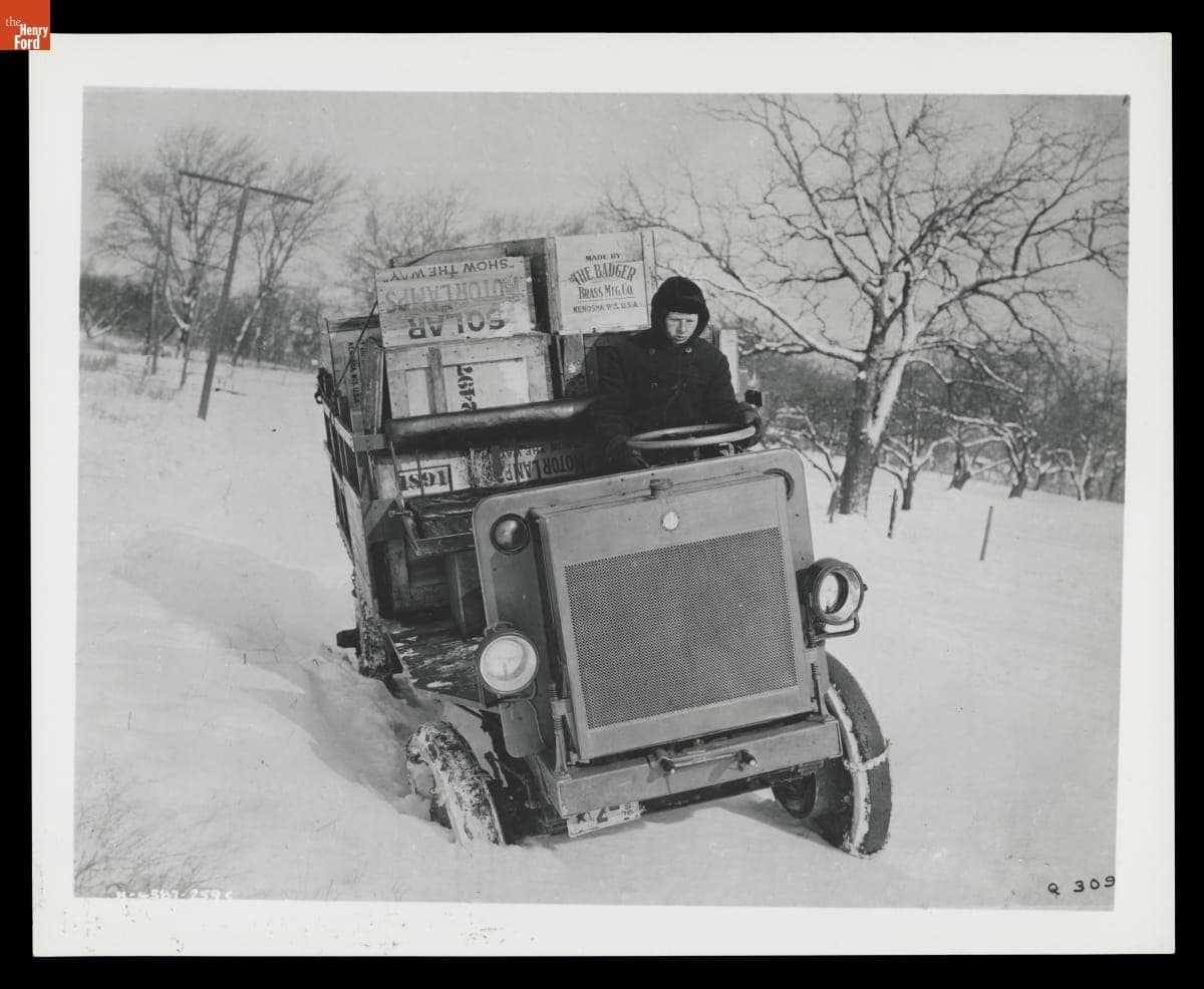 Young Man Driving a 1916 Jeffery Quad through Snow