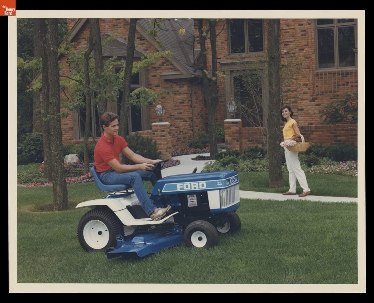 Man Driving a Ford Lawn Mower outside a House, 1984