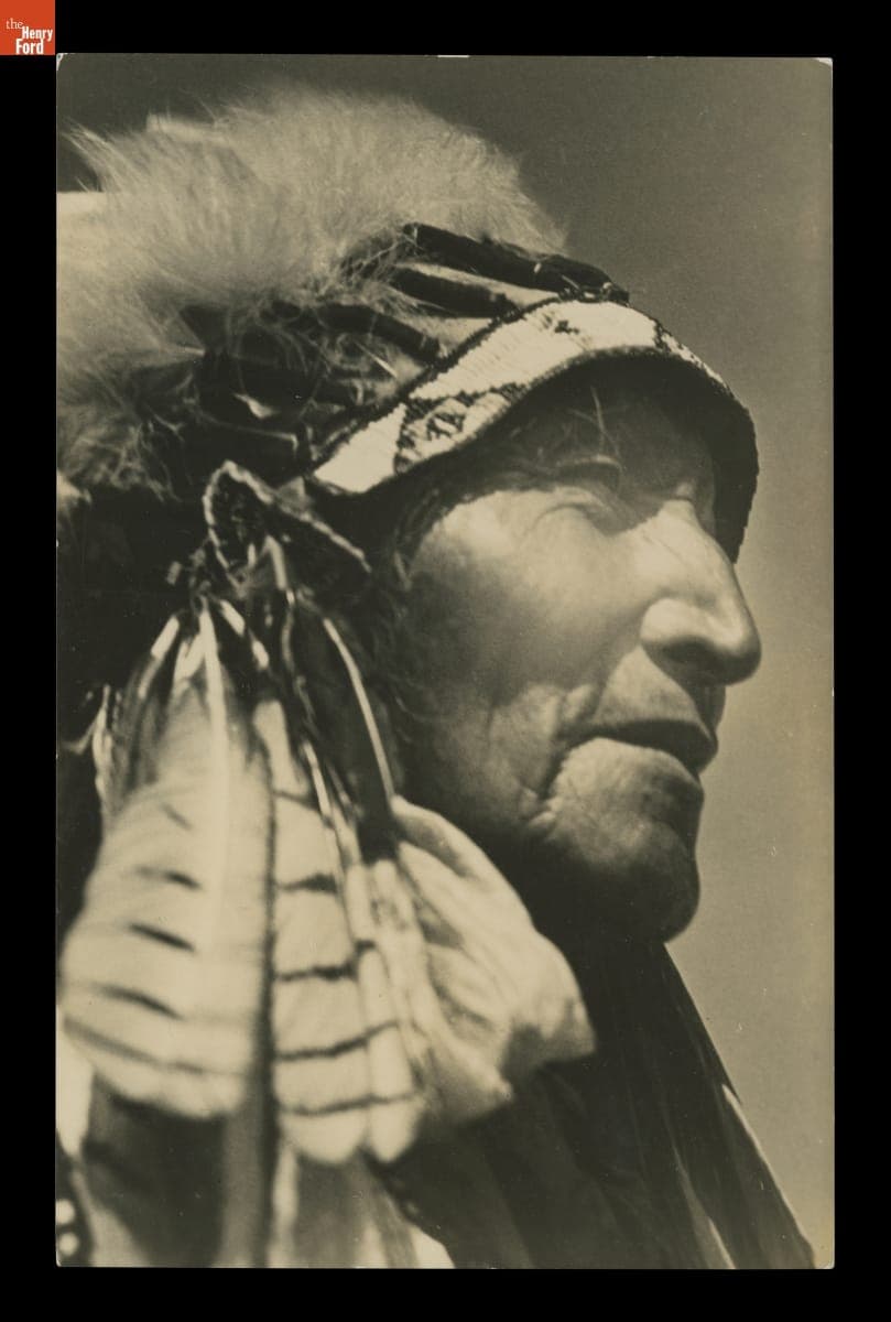 Indigenous Man in Feathered Headdress, circa 1925